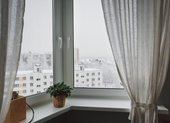 Winter landscape outside the window with curtains